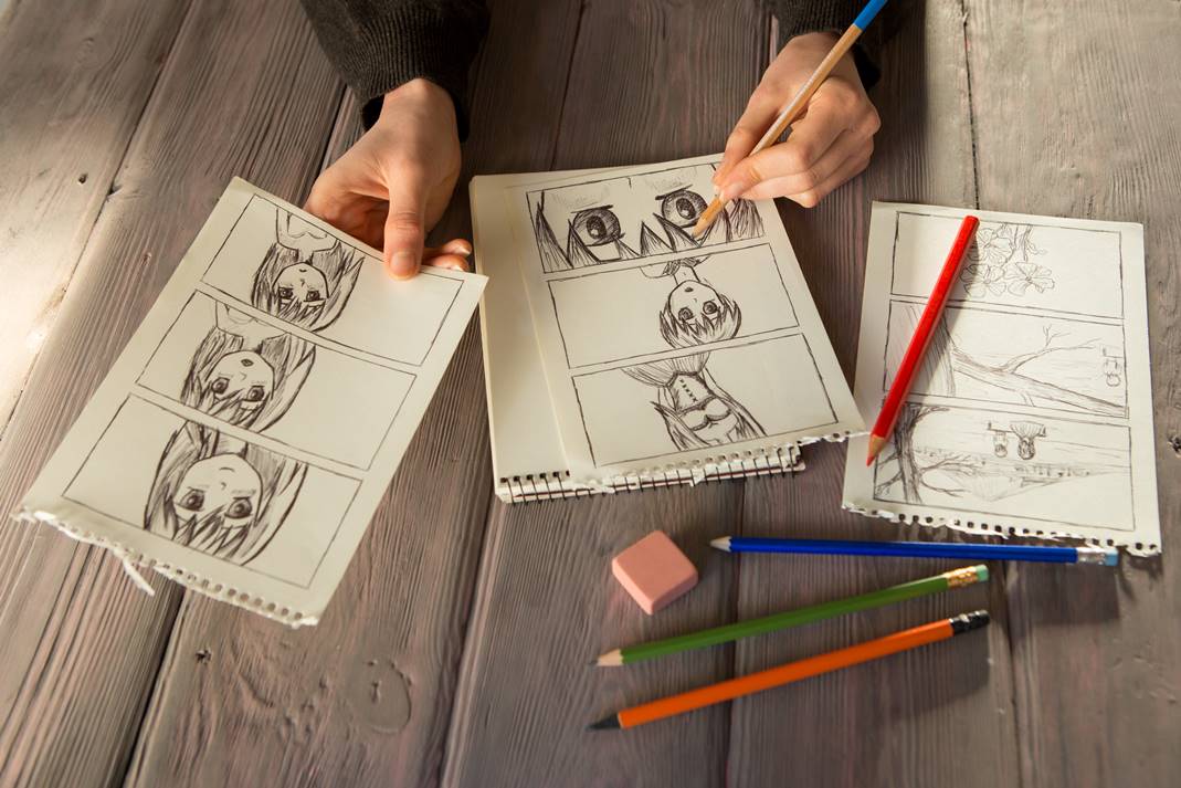 Child creating a storyboard inspired by anime books in class