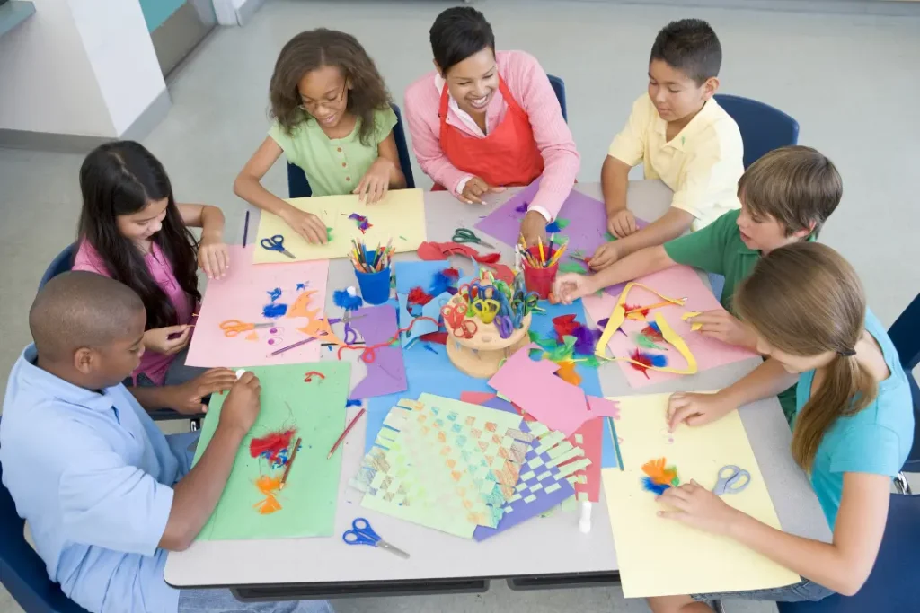 Children and adults painting together in a creative art class at a studio